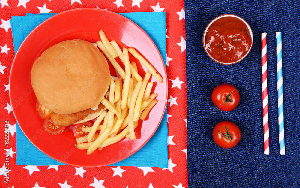 Hamburger, french fries and sauce on napkins top view