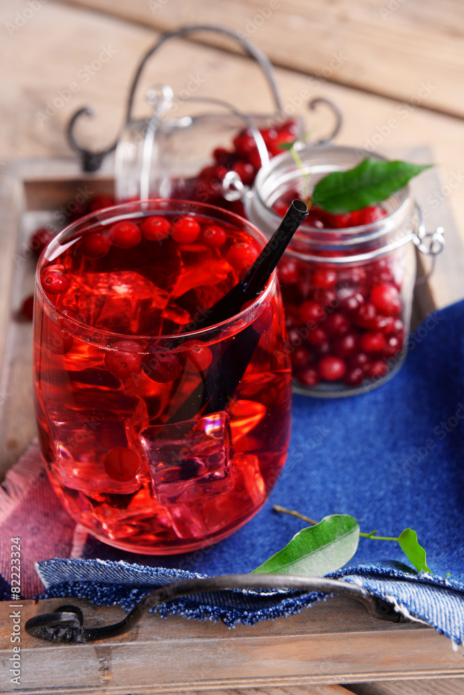 Compote with red currant on wooden tray, closeup