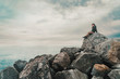 © Alex Photo - Woman sitting on stone near the sea
