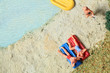 Miniature figurine couple relaxing at the beach