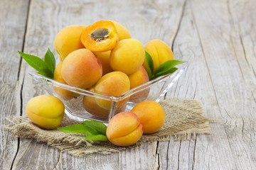 Sticker - fresh apricots in a bowl on wooden background