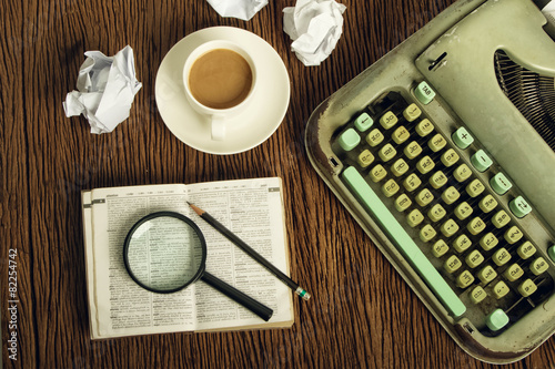 Fotografía The dictionary consider under a magnifier on writer's desk with