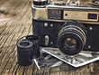 Leinwandbild Motiv old vintage camera closeup on wooden background