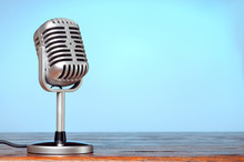 Vintage Microphone On The Table With Cyanic Background