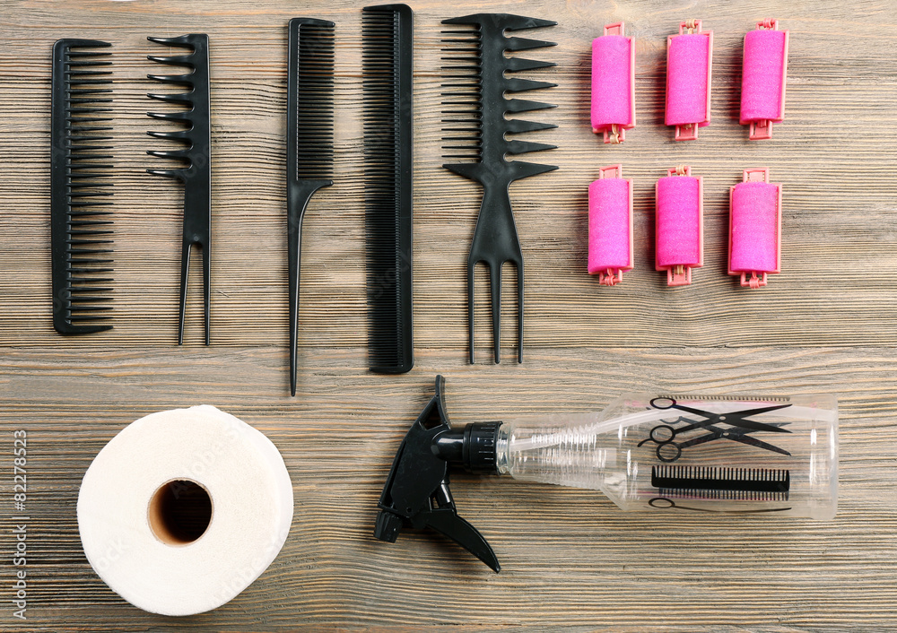 Hairdressing tools on wooden background