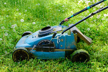 Old Lawnmower On Green Grass