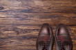 Classic male brown leather shoes on wood