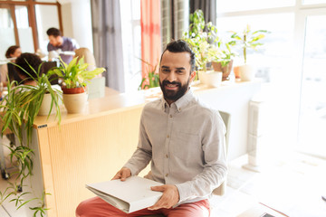 Wall Mural - happy creative male office worker with folfer