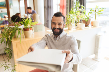 Wall Mural - happy creative male office worker with folfer