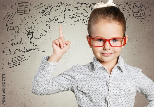 Fotografia Boy. Genius boy in red glasses near blackboard with formulas