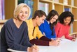 © BillionPhotos.com - Student. Happy Group Of Young Students Studying In Library