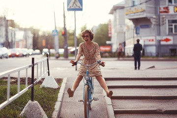 cheerful girl on a bicycle movement