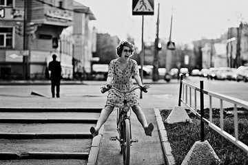cheerful girl on a bicycle movement