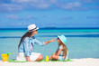 Mother applying sun protection cream to her daughter at tropical