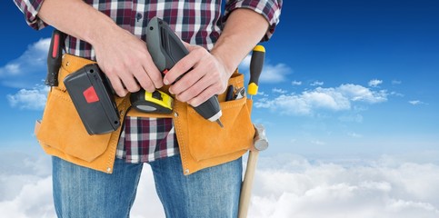 Poster - Composite image of male repairman holding drill machine