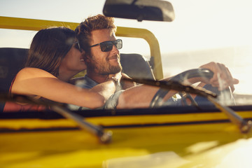 Wall Mural - Romantic young couple sharing a special moment on road trip