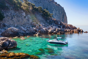 Wall Mural - Recreation on boat near the shore of beautiful mountain.