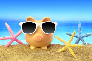 Wall Mural - Summer piggy bank with sunglasses and starfishes on beach