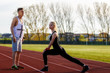 © czamfir - young health couple doing stretching exercise relaxing and warm