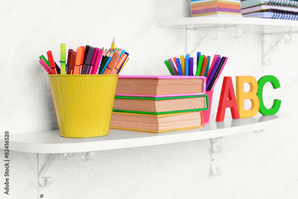 Shelves with stationery in child room close-up
