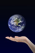© Pound - Woman hand holding Earth planet