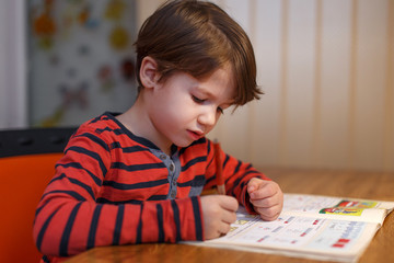 Little boy write maths exercise