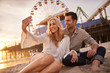 © Joshua Resnick - romantic couple taking selfie at sonica monica laying in sand
