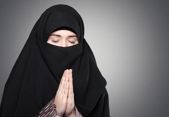 Allah. Portrait of beautiful woman with blue eyes wearing black