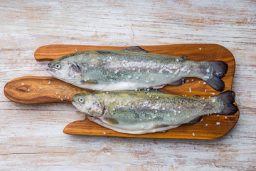 Fresh fish trout on the kitchen board