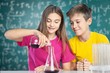 © BillionPhotos.com - Project. Young school kids doing a chemistry experiment with the