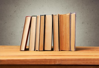 Sticker - Book. Vintage books on wooden table over retro wallpaper