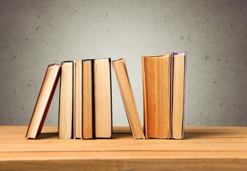 Sticker - Book. Vintage books on wooden table over retro wallpaper