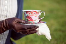 Vintage Lady Holds Cup Of Tea On A Picnic