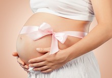 Abdomen. Pregnant Belly With Pink Ribbon