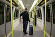 Man with Suitcase on an empty train.