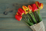 Fototapeta Kwiaty - Fresh beautiful tulips on a wooden background