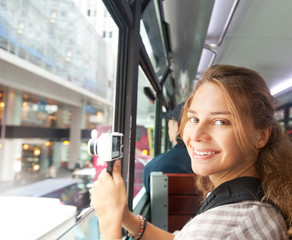 Wall Mural - young woman on the camera from the window of the tourist bus