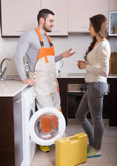 Poster - Workman and client near washing machine