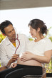 © akeeris - a male doctor using stethoscope check on pregnant woman