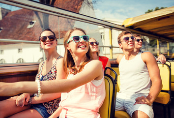 Wall Mural - group of smiling friends traveling by tour bus