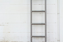 Steel Ladder On The Dirty Wall