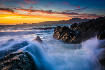 Wall Mural - Waves and rocks in the San Francisco Bay at sunset, seen from Ba