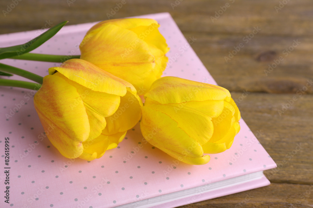 Beautiful tulips on wooden background