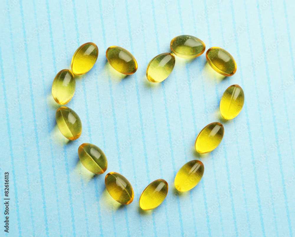 Heart of cod liver oil, on blue background