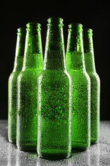 Poster - Glass bottles of beer on dark background