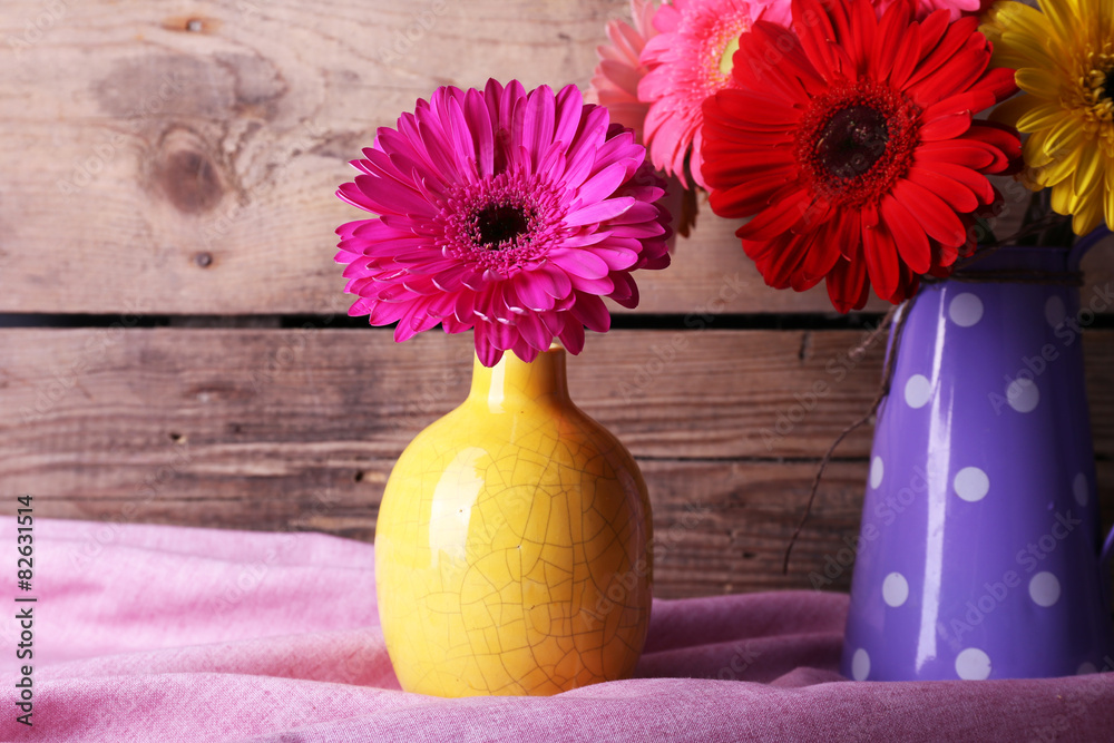 Still life with beautiful bright gerbera flowers on wooden background