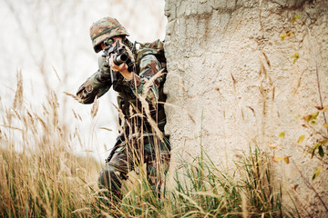 Wall Mural - military soldier shooting an assault rifle