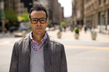 Poster - Young African Asian man in New York City serious face portrait