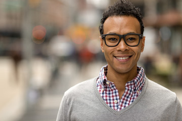 Poster - Young African Asian man in New York City smile face portrait