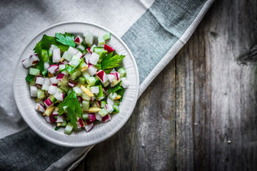 Wall Mural - Vegetable salad on wooden background